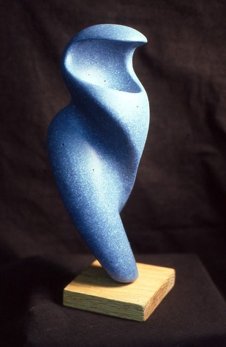 Carved abstract sculpture with a smooth, twisting blue form